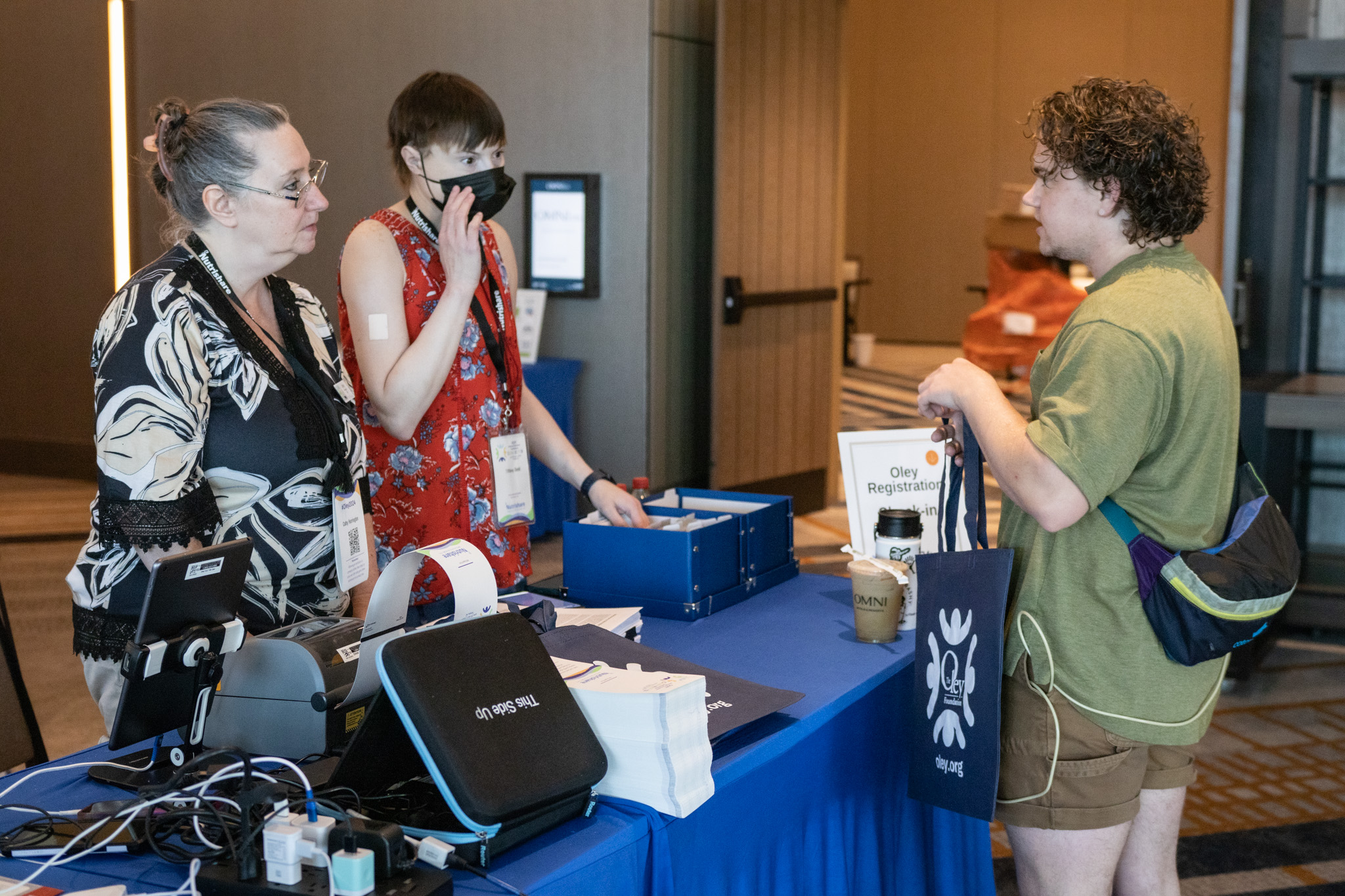 Attendee checking in at the Oley conference registration desk